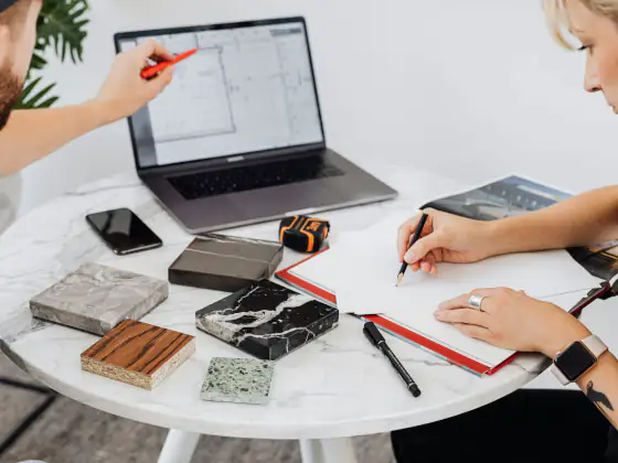 Team reviewing strategy around laptop